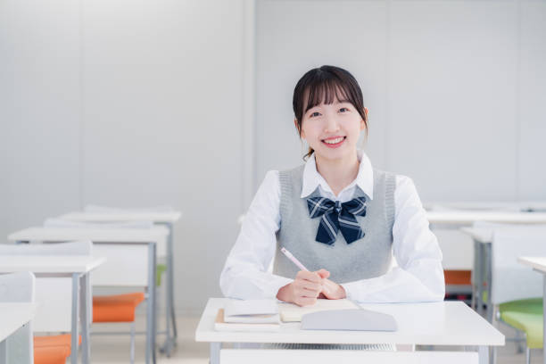 istock High school girls studying by themselves in a classroom 1469334191