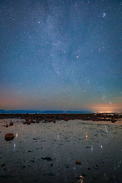 Night Star Reflection on the Beach in Campbell River, Vancouver Island, BC, Canada stock photo