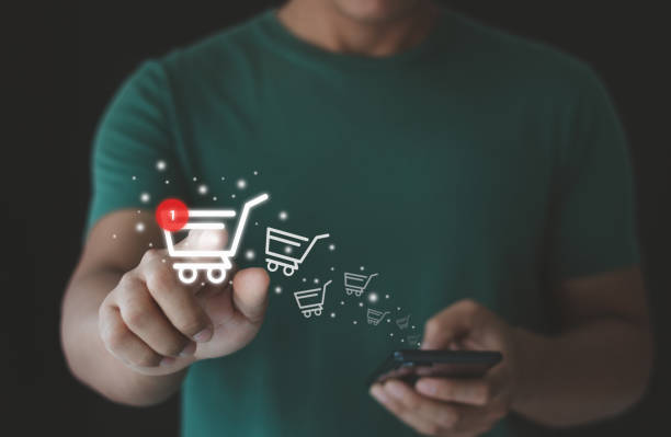 istock Man using a smartphone with online shopping, marketplace website with virtual interface of online Shopping cart part of the network, Online shop business with selecting shopping cart. e-commerce. 1469343983