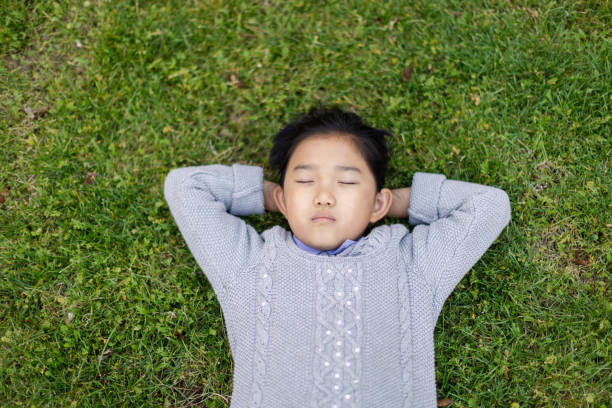 istock Little Girl Napping on the Grass 1469344237