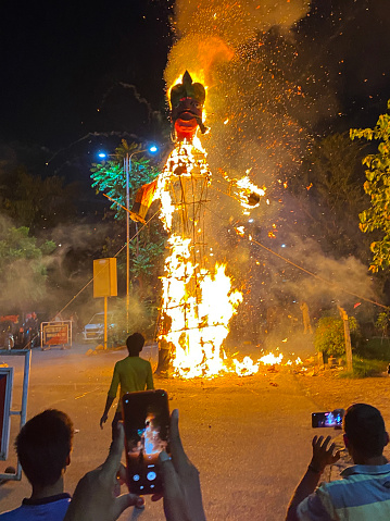 Noida, Uttar Pradesh, India - May, 10 2022: Stock photo showing an effigy of the demon Ravana being burned as part of the Hindu festival of Dussehra, which is also known as Dasara, Dashain or Vijayadashami.