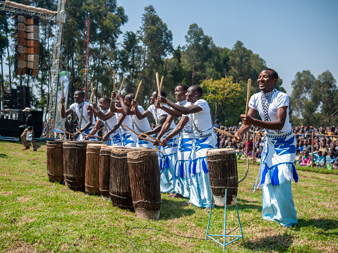 Kinigi, Rwanda - July, 2014: male performers are playing rwandan traditional instruments at the gorilla naming ceremony.