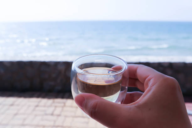 istock hot tea or drinking tea near the sea 1469349596