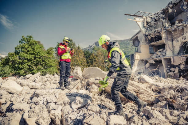rescue forces search through a destroyed building stock photo