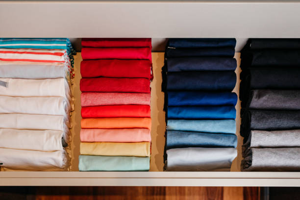 istock organization - Drawer with folded t-shirts organized by color 1469353148