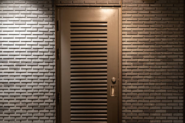 istock metal door in dark brick wall. 1469356472