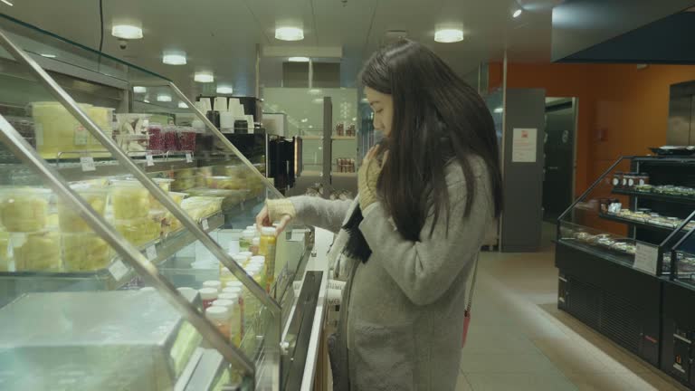 Asian businesswomen buying food in supermarket.