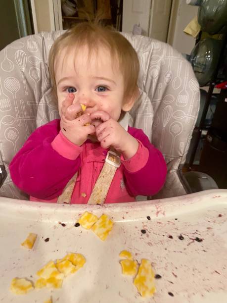 istock Messy eating blue eyed baby 1469358594