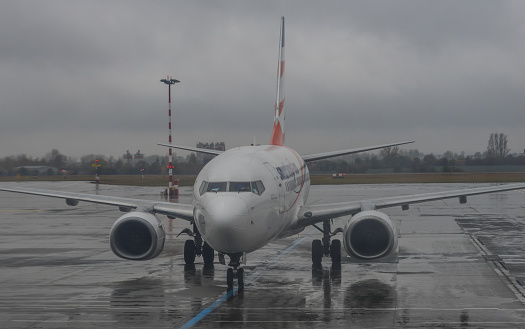 Prague, Czech - Oct 28, 2018. Passenger airplane docking at the Vaclav Havel Airport Prague (PRG) in the rainy day.