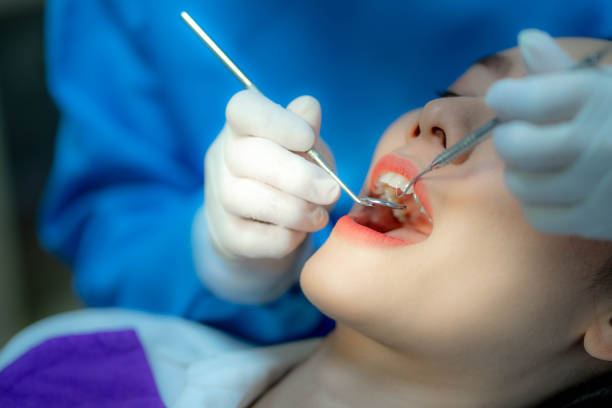 istock Dentist examining a patient's teeth in the dentist. 1469368987