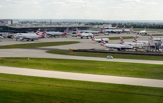 Heathrow, UK - April 26, 2022: Aerial view of Terminal 5 at Heathrow Airport on a sunny spring afternoon with planes from American Airlines and British Airways in action.
