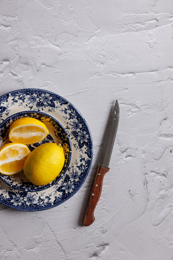 Istanbul, Turkey-January 6, 2023: Lemons on dark blue ceramic plates with floral and nature pattern. Shot with Canon EOS R5.