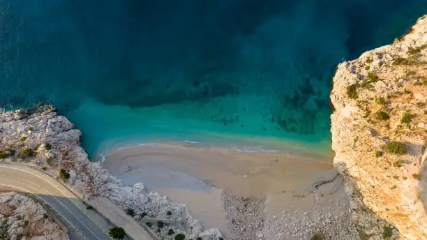 Drone photos of one of the most beautiful beaches in Turkey. The beach is situated at a distance of 20 km from Kaş and 7 from Kalkan. at a point where an extremely narrow valley towered by steep cliffs and forests joins the sea shore in the cove of the same name as the beach Kaputas