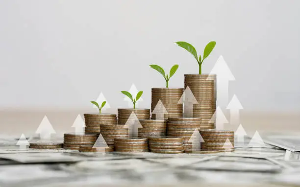 Photo of stack of silver coins with the chart in Passive income financial concept and financial investment business stock growth. finance freedom concept.