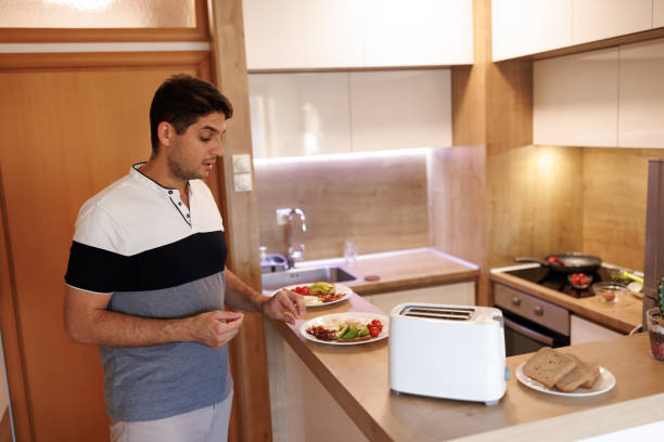 istock Young man preparing breakfast in the kitchen at home 1469387808