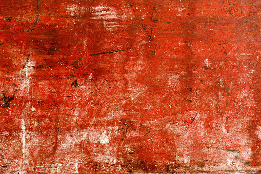 Old painted wood with chipped red paint. Grunge style background