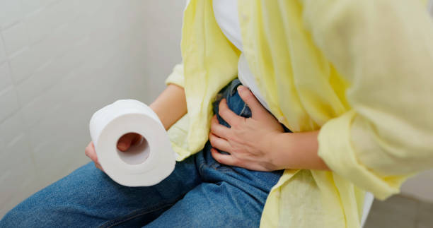 woman use tissue in toilet close up asian women suffer from constipation hold and squeezing toilet paper roll sitting in bathroom blood and guts stock pictures, royalty-free photos & images