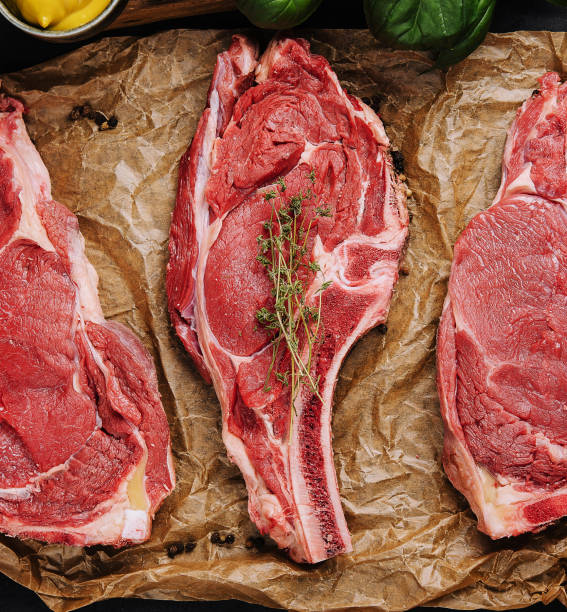 istock Three raw beef steaks on a wooden chopping board 1469401635