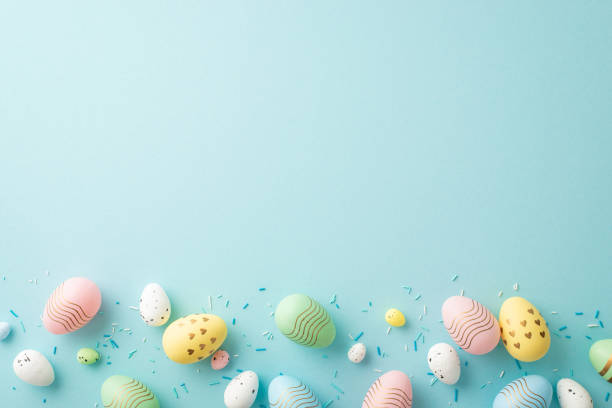 istock Easter celebration concept. Top view photo of colorful easter eggs with creative design and sprinkles on isolated pastel blue background with blank space 1469401707