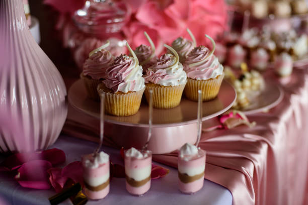 istock Table with cupcakes in pink color for party. Candy bar. 1469405958