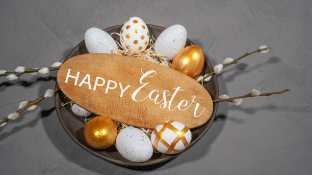 istock HAPPY EASTER holiday celebration backgroud - Golden painted easter eggs in a plate with wooden sign with text, on concrete table texture, top view 1469406048