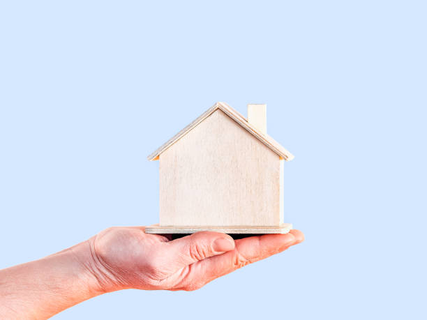 istock Mortgage concept by house in hand 1469407108