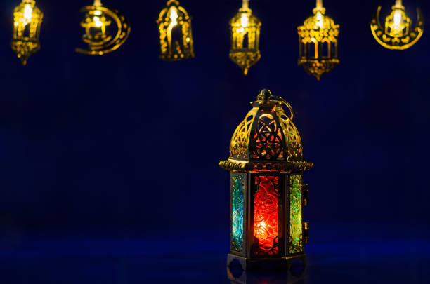 istock Golden lantern puts on dark blue background with decorated lights 1469407699