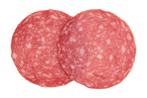 two pieces of sliced salami sausage laid out to create layout, salami sausage slices isolated on white background