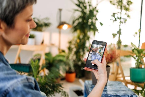 istock Florist woman using mobile phone 1469423355