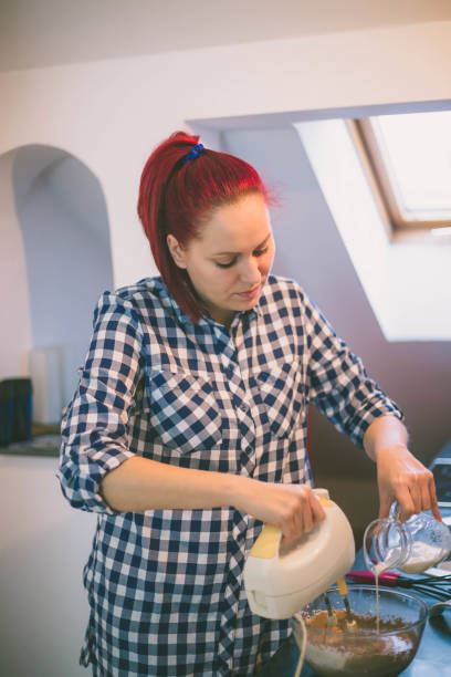 istock Confectioner woman making delicious cream for cupcakes 1469434268