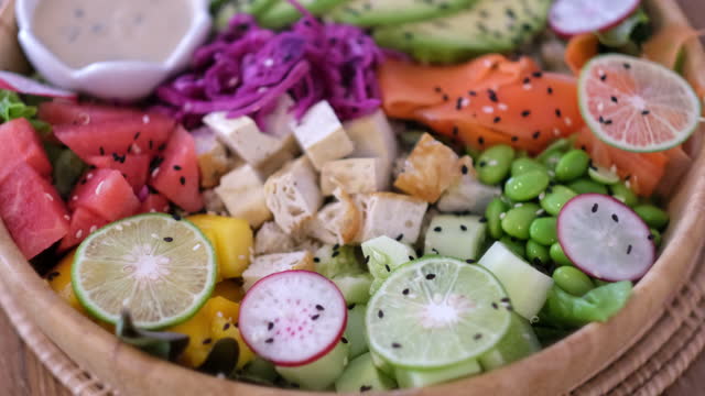 Top view in rainbow colored fruit and vegetable lunch bowl. Healthy eating. 4k footage