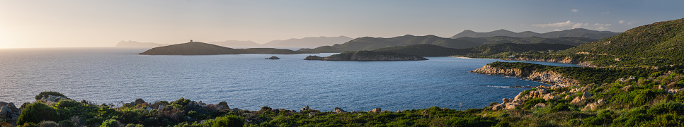 Panoramic view of Mediterranean Sea shore, Capo Malfatano, Island Isola di Tueredda, Tuelada\n South Sardinia. Seascape at sunset, Italy.