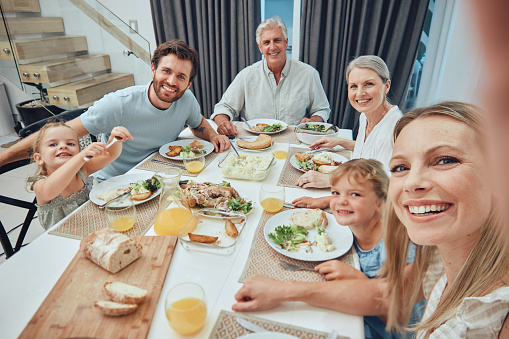 Family, selfie and dinner with generations and food, parents with grandparents and children smile for picture with quality time together. Memory, big family and happiness with nutrition and meal.