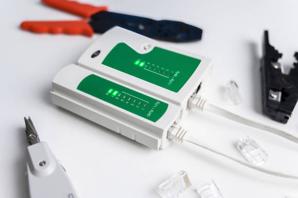 istock Cat6 RJ45 cable network tester. Twisted pair test tool on the desktop. 1469439135