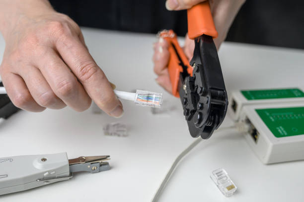 istock RJ45 network cable crimping with crimping tool, cable twisting tool, twisted pair Ethernet UTP Cat 6 1469439310