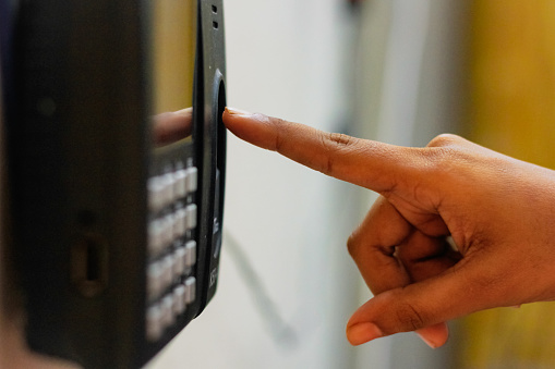 Index finger signing in infront of a fingerprints scanner device