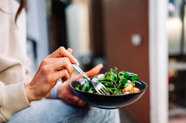 istock Woman's hands eat wegetables salad 1469442906