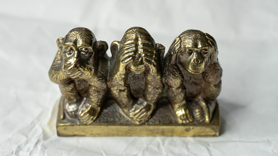 Souvenir figurines of the three monkeys, symbolizing the Buddhist idea of non-doing of evil, detachment from false - see nothing, hear nothing, say nothing