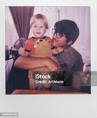 istock Real Instant photo of a little girl with father enjoying time together in a cafe 1469454190