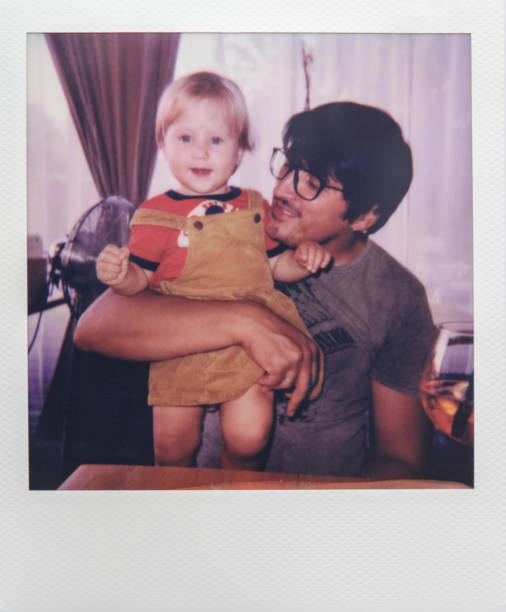 Real Instant photo of a little girl with father enjoying time together in a cafe stock photo