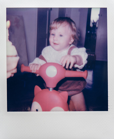 Child with birthday present.  Polaroid photo.