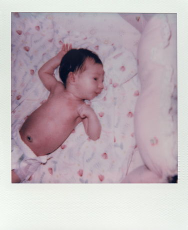 Newborn baby at home.  Polaroid photo.