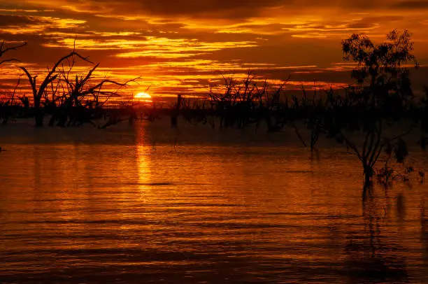 Photo of Bright orange sunset over inland lake