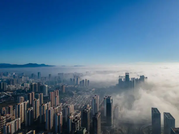 Photo of Aerial view of urban buildings in the morning fog