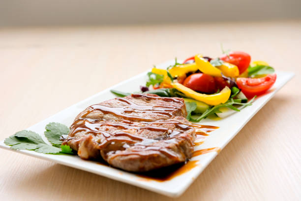 Grilled rump steak with fresh vegetables, close-up, no people