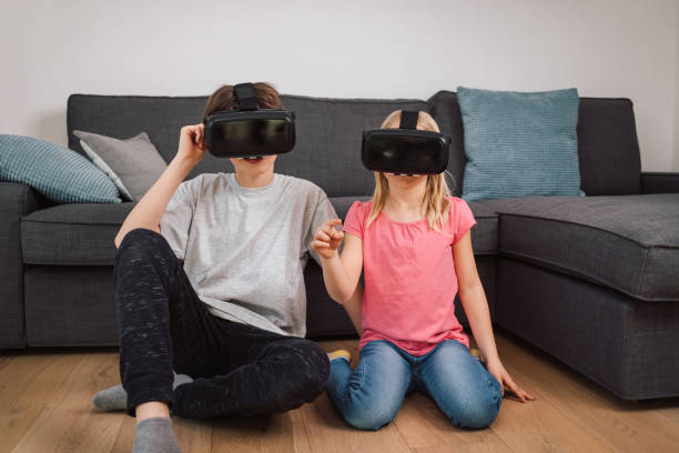 istock Two children, brother, and sister using VR headsets 1469457653