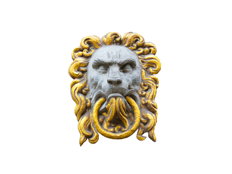 old medieval sculpture of a lion on a stone covered with gold leaf