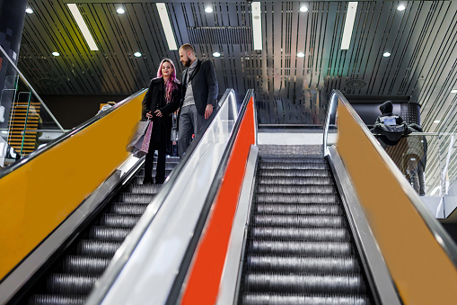 businesspeople on escalators, blurred motion, long exposure,