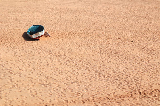 Shot taken in a beach where a boat was forgotten in the sand of a beach in Las Palmas de Gran Canaria, Canary Islands