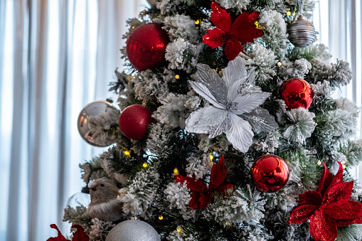 decorated Christmas tree with red and gray decorations close up